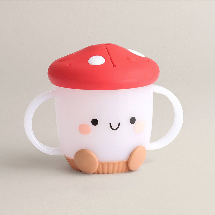 Children's cup with mushroom design on a beige background
