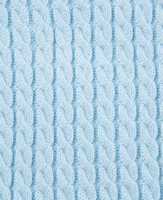 close up of the cable knit deign of the blanket