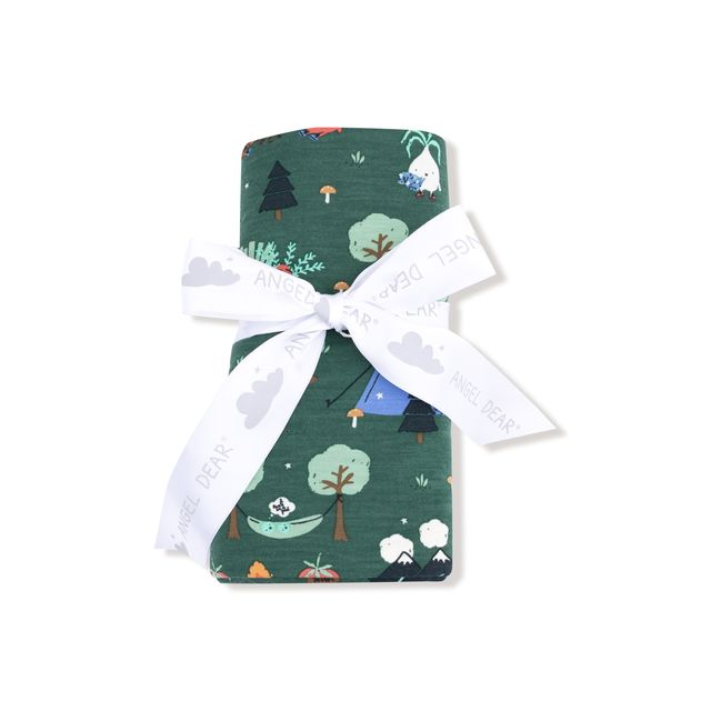 Green baby swaddle with nature-themed design and a white ribbon on a white background