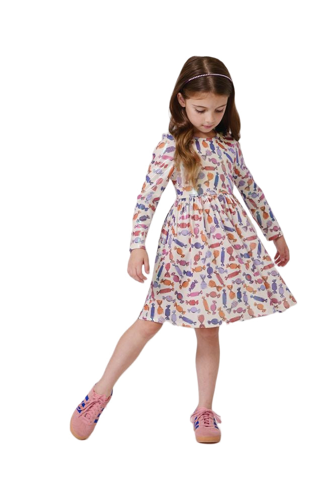 Young girl wearing a colorful dress with a pattern on a white background