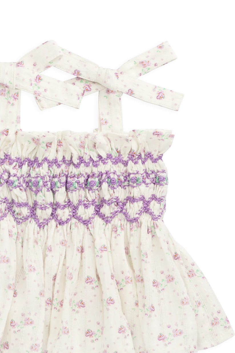 Floral top with purple lavender smocking pattern on a white background