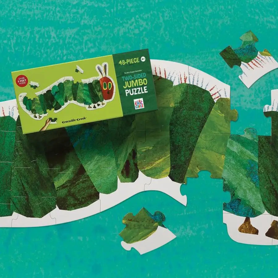 Jigsaw puzzle with pieces laid out on a green background, featuring a box labeled '48-Piece Jumbo Puzzle' on top.