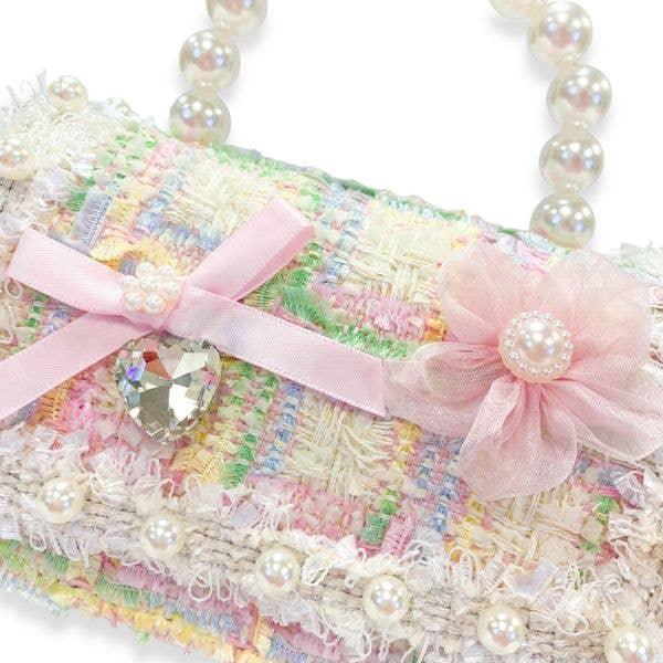 close up of the fabric, texture and colors in the bag and embellishments