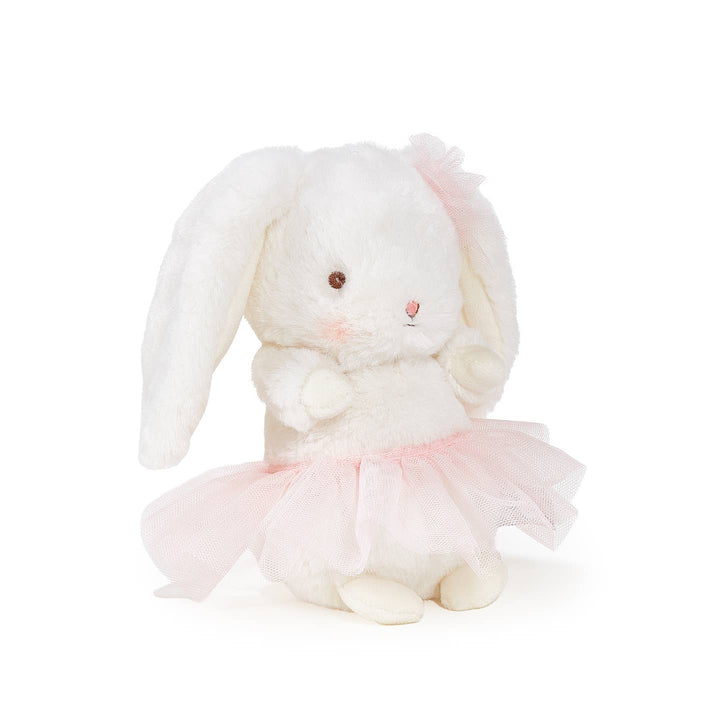 Plush rabbit toy in a pink dress on a white background