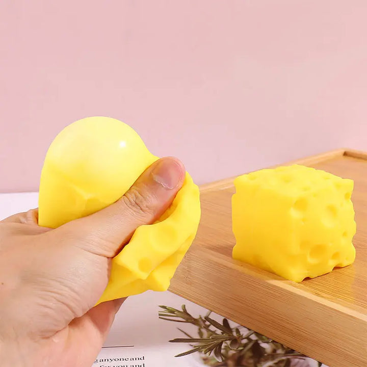 Yellow squishy toy being held 