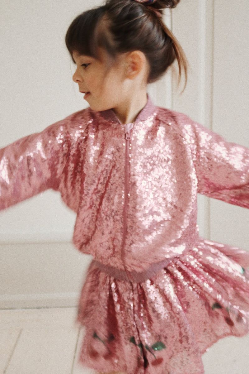 This picture shows the little girl spinning around, but you can see the pink sequin jacket from the front. 