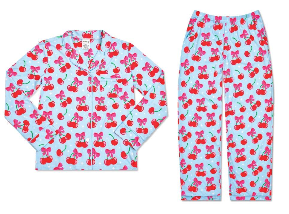 loungewear set: top is long sleeves and bottoms are long pants. blue base color with red cherries and pink bow that ties the cherries together