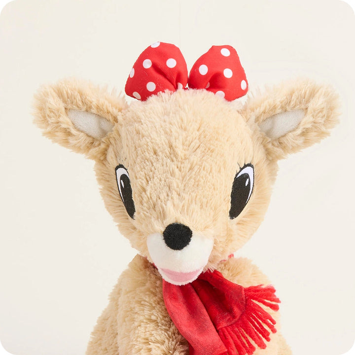 Plush deer toy with a red bow and scarf on a white background