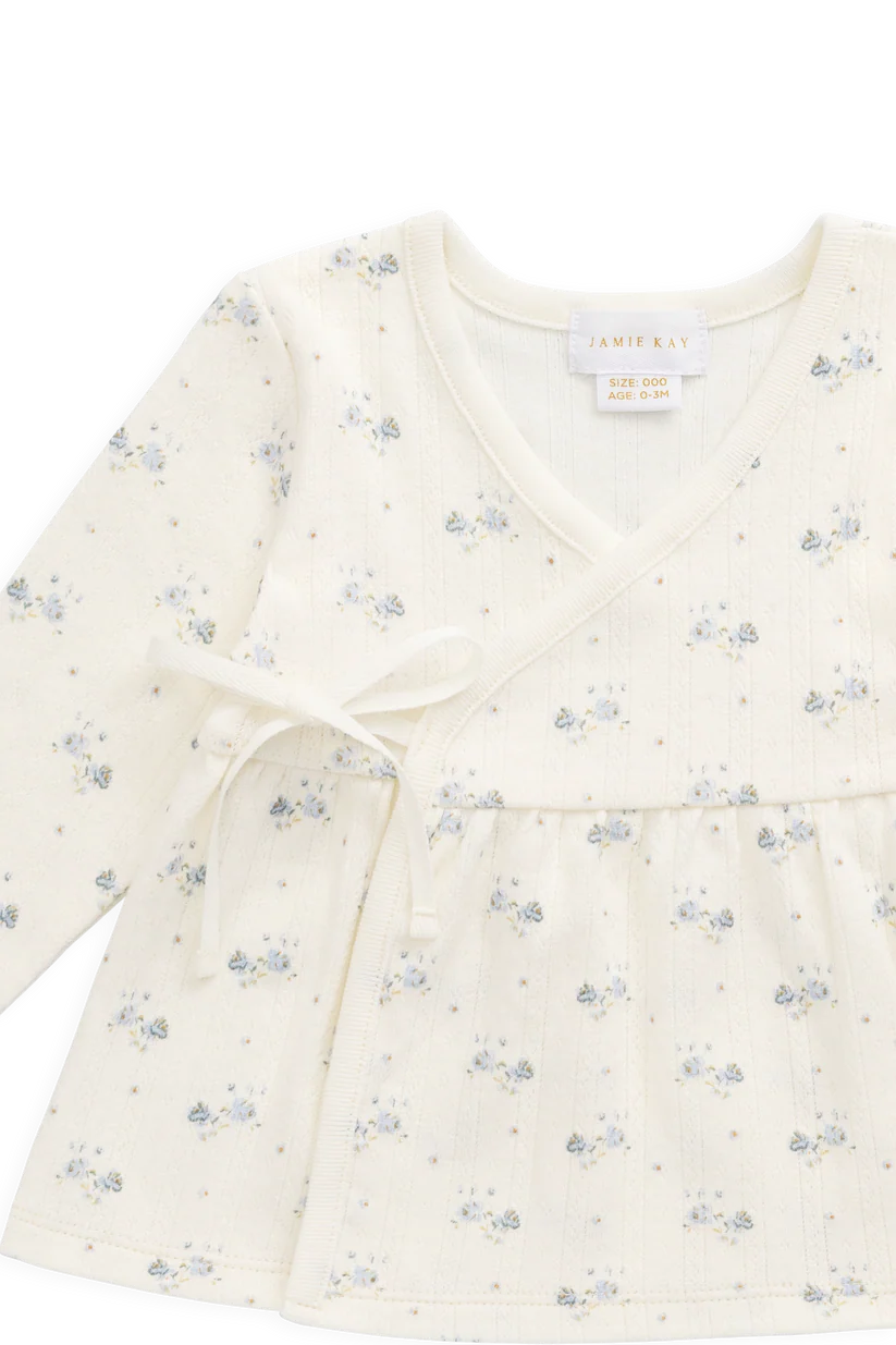 Floral patterned baby wrap top on a white background