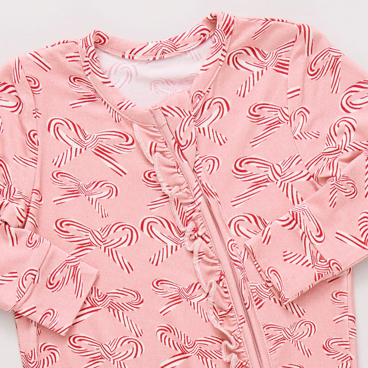Pink baby outfit with candy cane  bow pattern on a white background