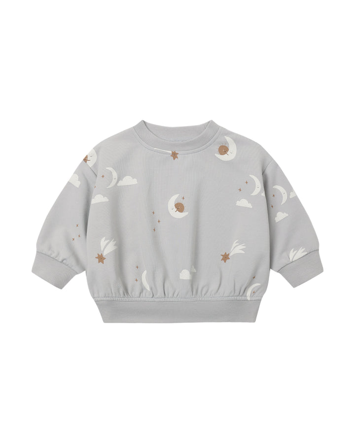 A light gray long-sleeve crewneck sweatshirt with an all-over celestial print of white crescent moons, clouds, and stars with brown centers, shown on a plain white background.