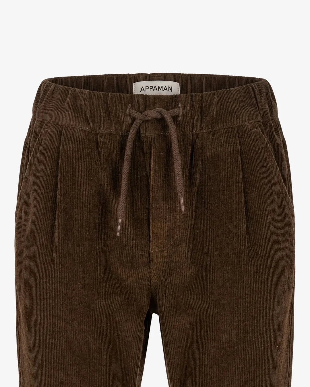 Close-up of a pair of dark brown corduroy pants with an elastic waistband and matching drawstring, featuring a visible 'APPAMAN' brand label.