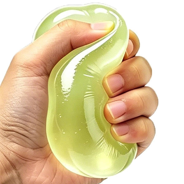 A hand squeezing a translucent, glossy, light green squishy stress toy against a plain white background.