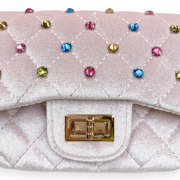 A close-up of a quilted light pink handbag with rhinestone embellishments in multiple colors and a gold-tone turn-lock clasp on a white background.