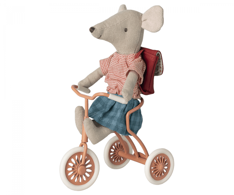 mouse riding the coral tricycle. mouse has magnetic hands