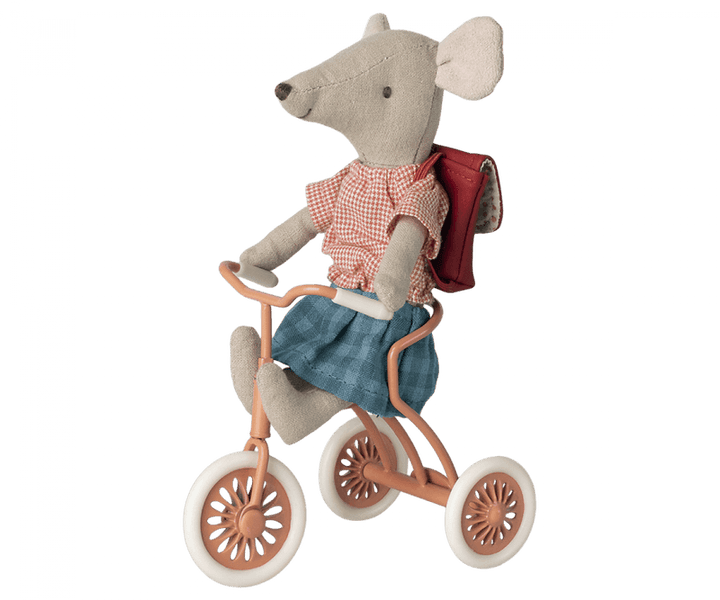 mouse riding the coral tricycle. mouse has magnetic hands