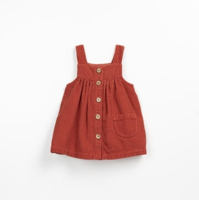 burnt orange corduroy dress with buttons going down the center. pocket in the front