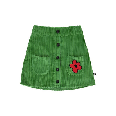 short green corduroy skirt with redish flower on the left pocket. Black buttons going down the center