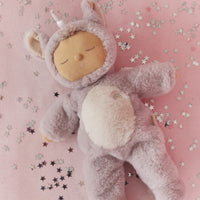 Plush toy resembling a baby in a unicorn costume on a pink background with stars.