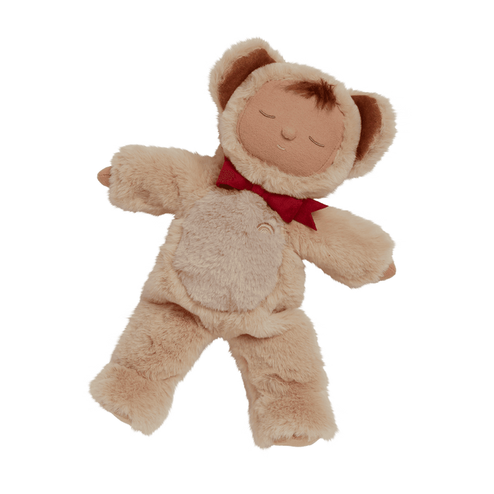 baby doll dressed as a teddy bear with red bow around his neck. 