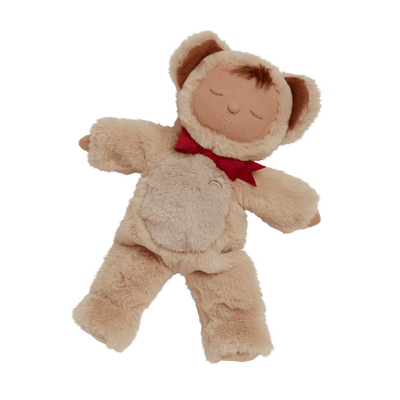 baby doll dressed as a teddy bear with red bow around his neck. 