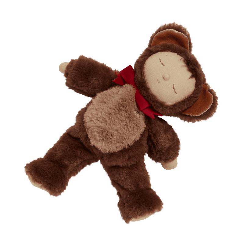 baby doll dressed as a teddy bear with red ribbon under his neck