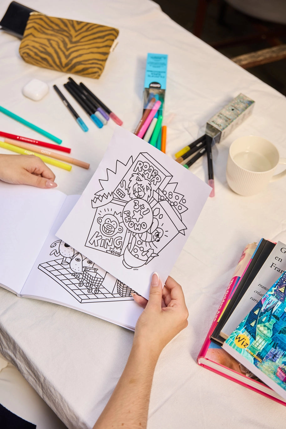 inside pages of a cozy art coloring book and some markers