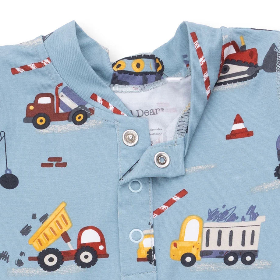 Children's shirt with construction vehicle pattern on a light blue background