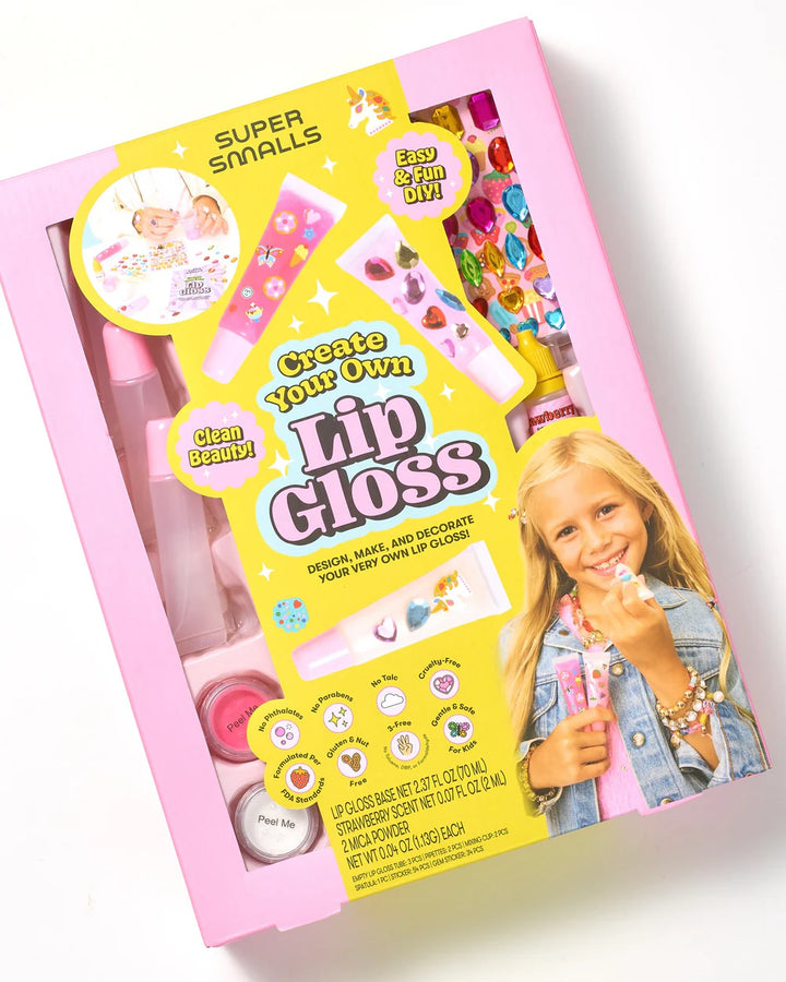 Create Your Own Lip Gloss kit packaging with a child holding lip gloss on a white background
