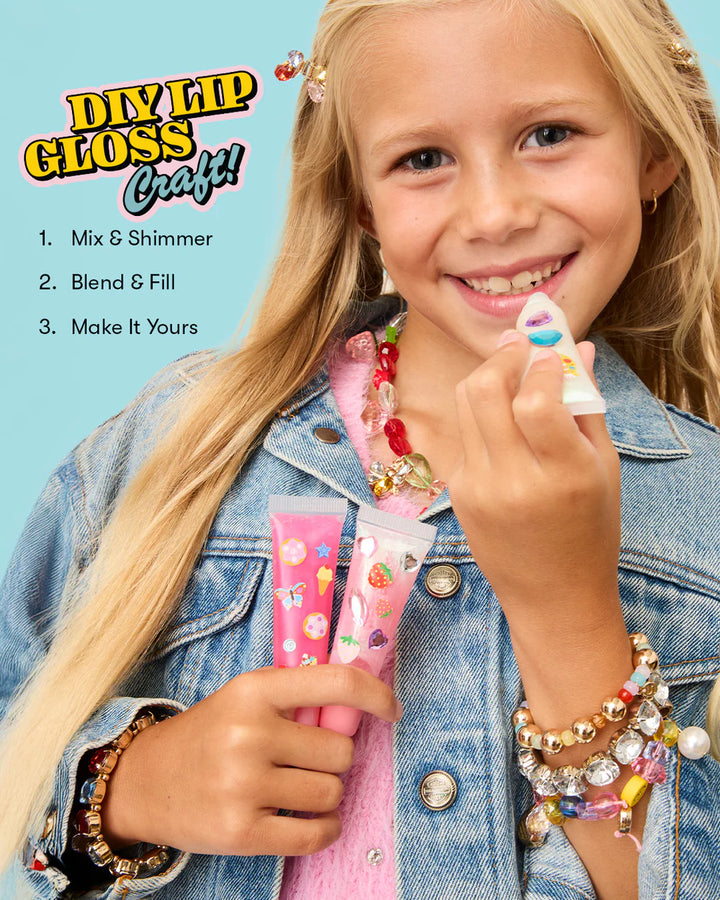 Girl applying makeup with DIY lip gloss craft kit on a blue background
