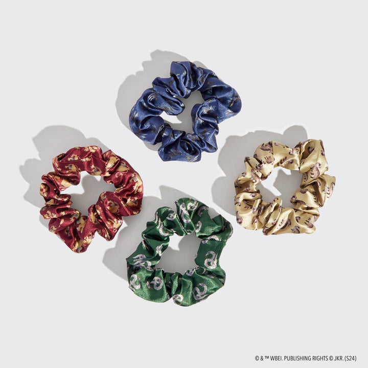 4 different satin scrunchies each with crests of one of the houses of Harry POtter on it. 