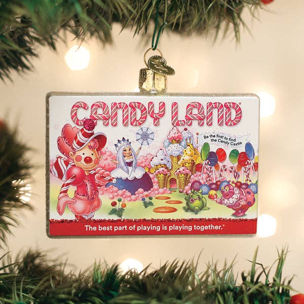Candy Land Christmas ornament hanging on a tree with lights in the background