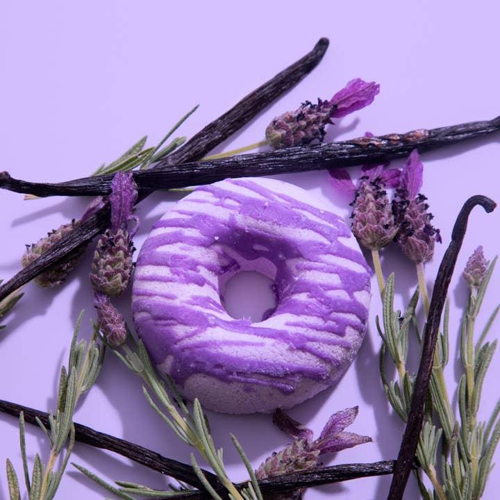 purple bath bom doughnut with purple drizzle. purple in color and lavender vanilla in scent. 