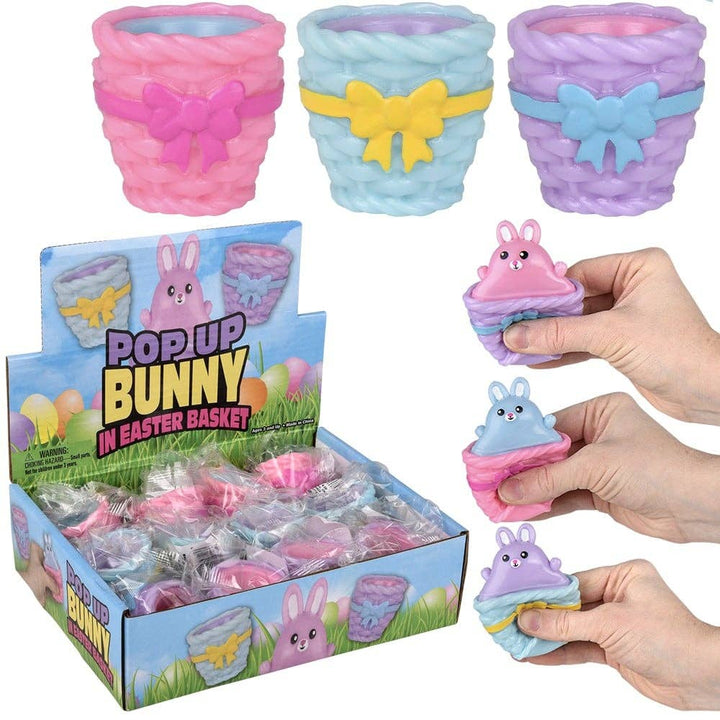 Pop-up bunny toys in Easter basket packaging with colorful bows.