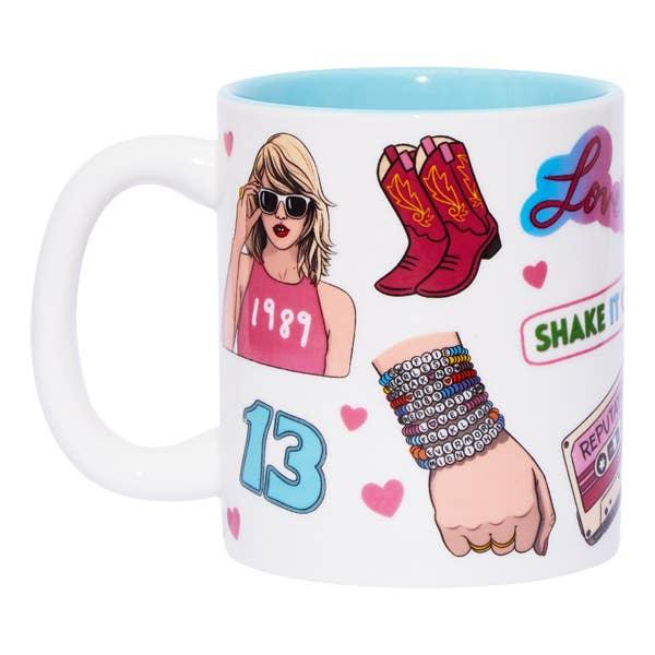 this part of the mug shows Taylor Swift wearing a tank that says 1989, cowboy boots, the number 13 and friendship bracelet stack
