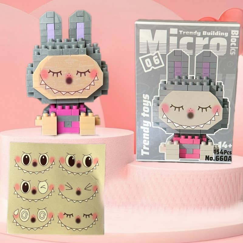 Toy building block figure with packaging and face parts on a pink background