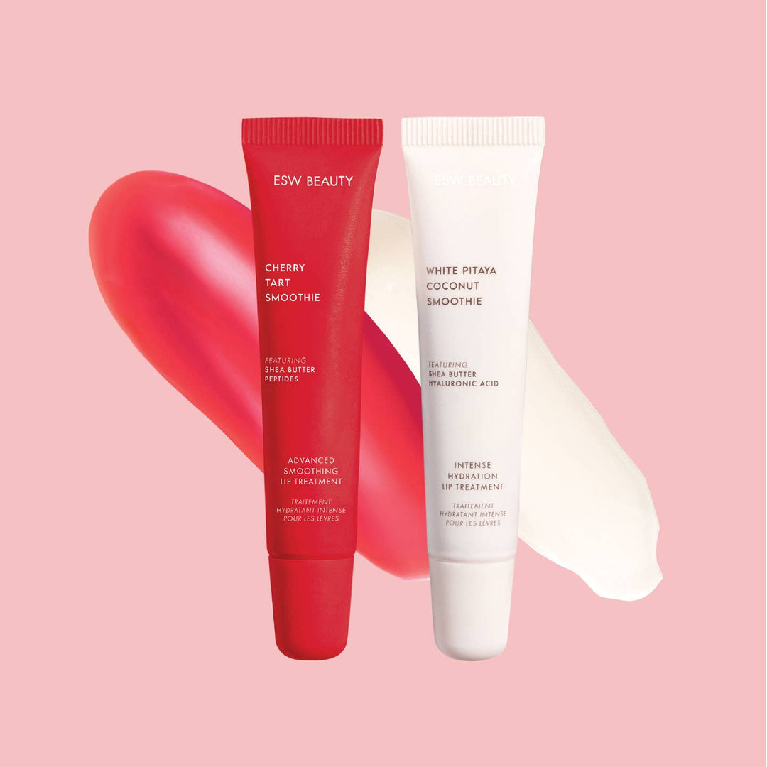 Two lip treatment tubes, one red and one white, on a pink background with heart shapes.