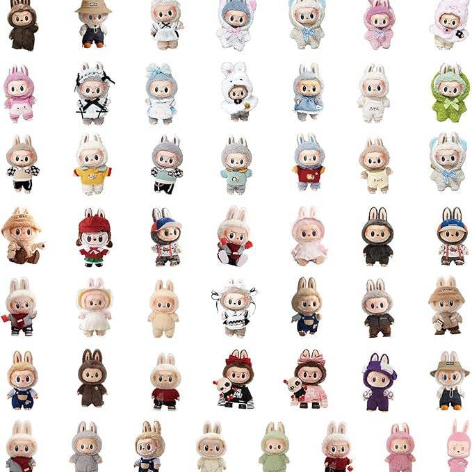 Collection of small figurines in various outfits on a white background
