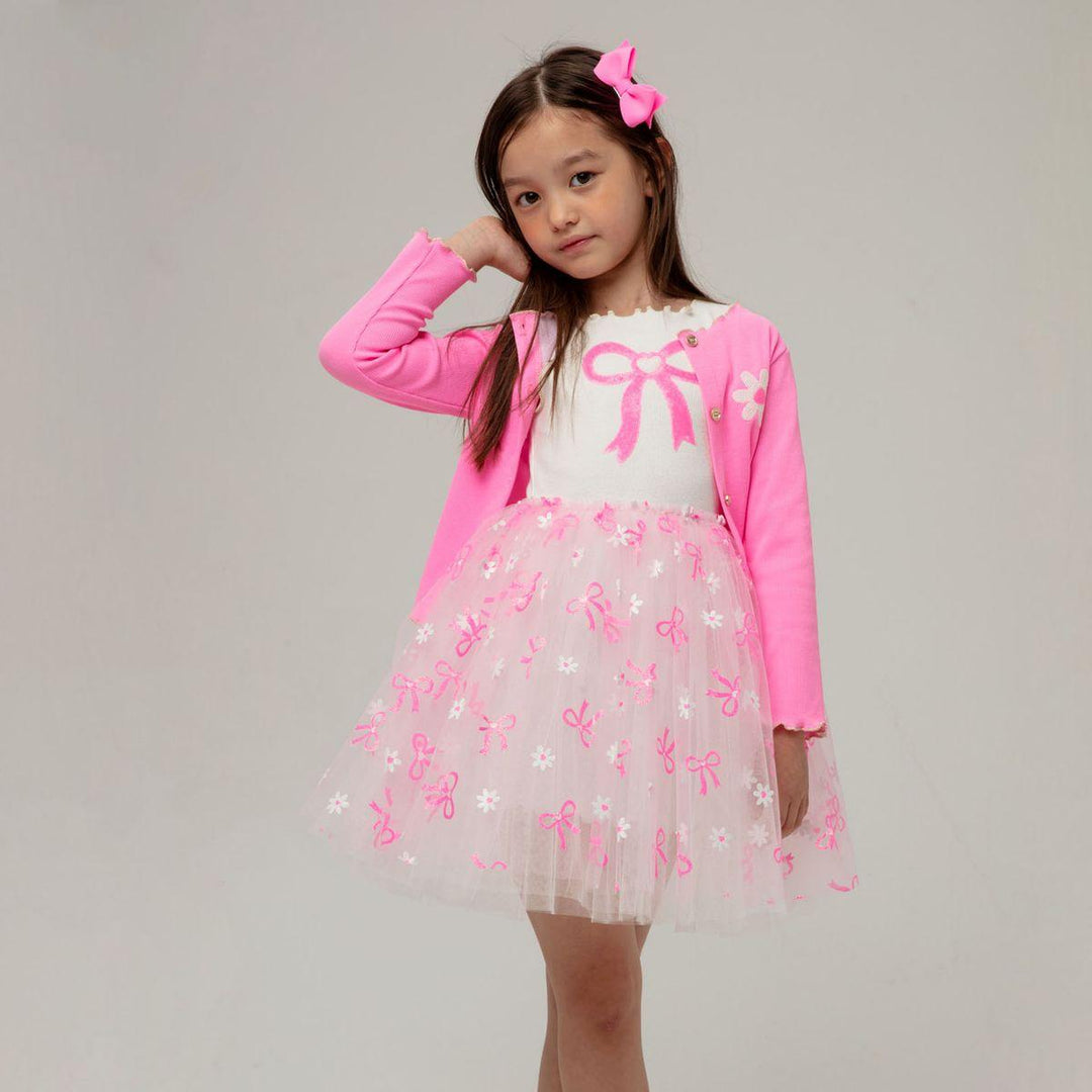 little girl modeling the tulle dress with the hot pink cardigan as a layer. 