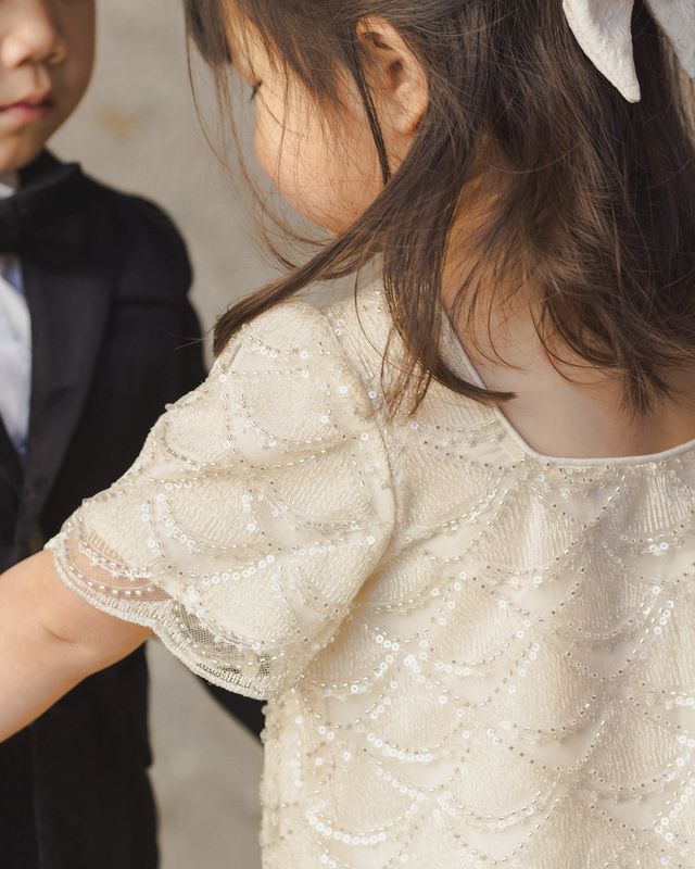 Close-up of a child wearing a sparkly dress with a blurred background