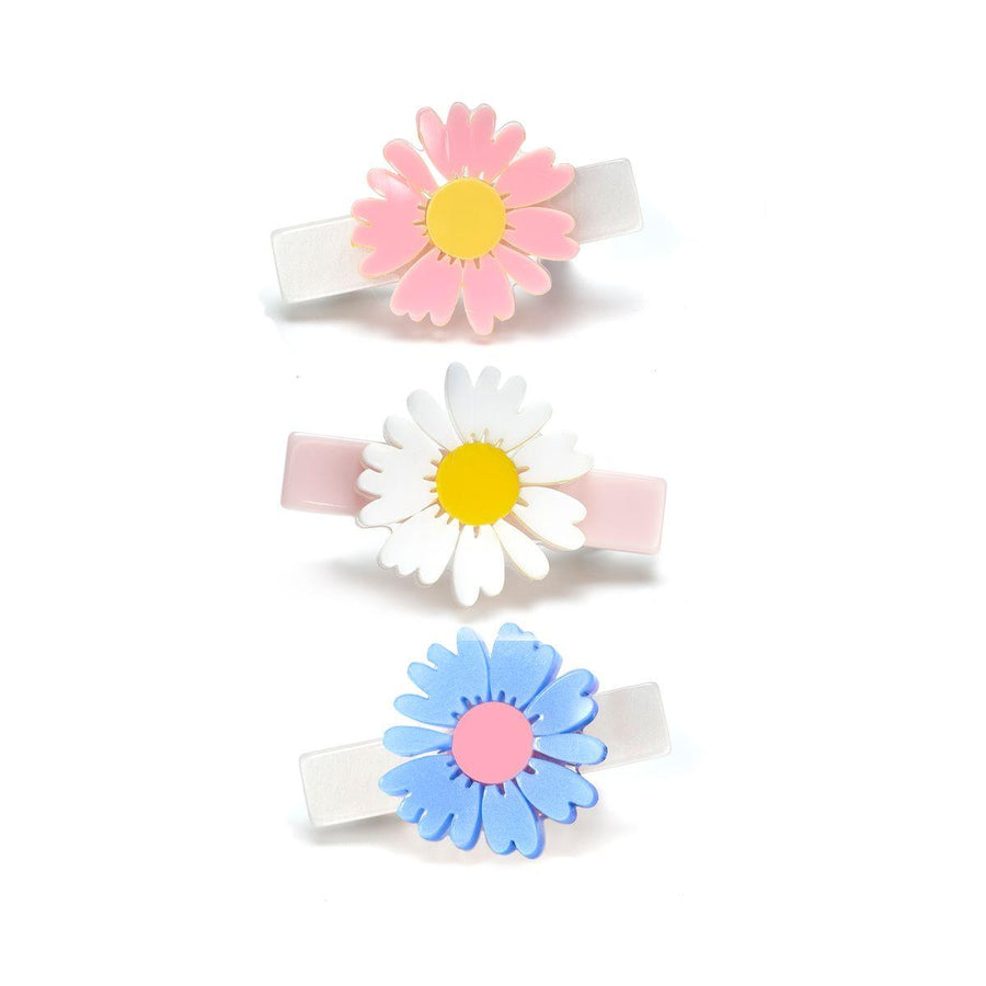 set of 3 clips each with a daisy on it white, pink and blue
