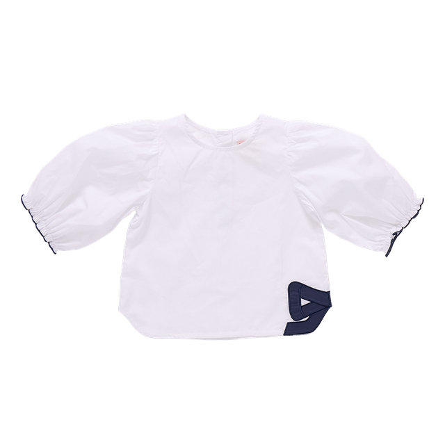 whtie blouse with navy bow on the botton right corner of the shirt. 