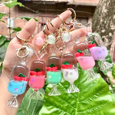 candy key chain with colored liquid with floating cherries. they come in 6 colors: purple, blue, pink, green, white and blue