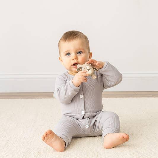 baby chewing on the puppy teether 