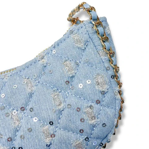 Light blue denim pouch with sequins and a gold chain handle on a white background