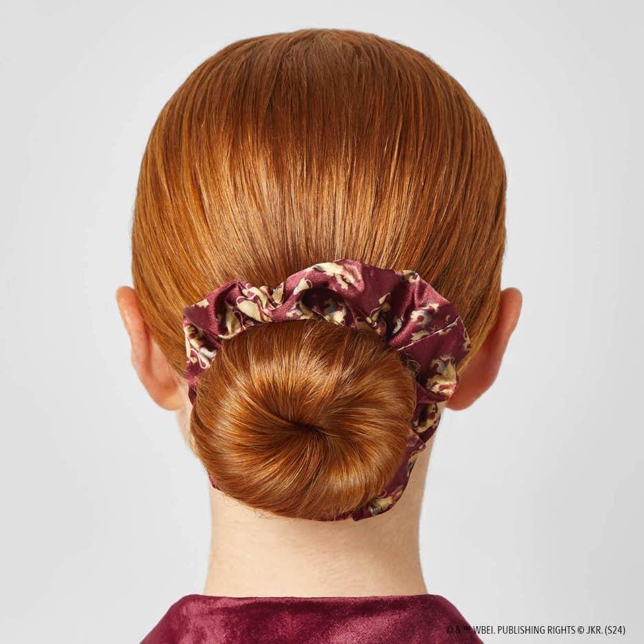 picture of a girl with her hair in a satin burgundy scrunchie for Gryffindor. 