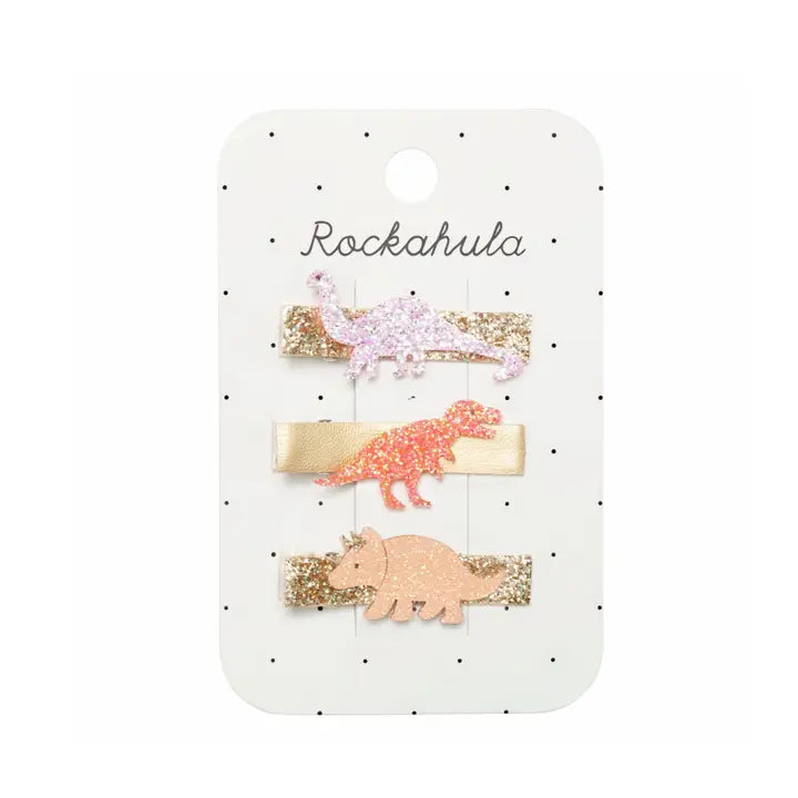 bar clips wrapped in gold glitter, each a top with a sparkly dinosaur. 