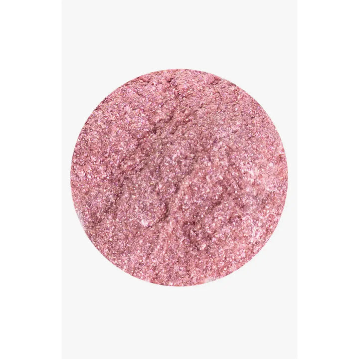 Pink glittery powder on a white background