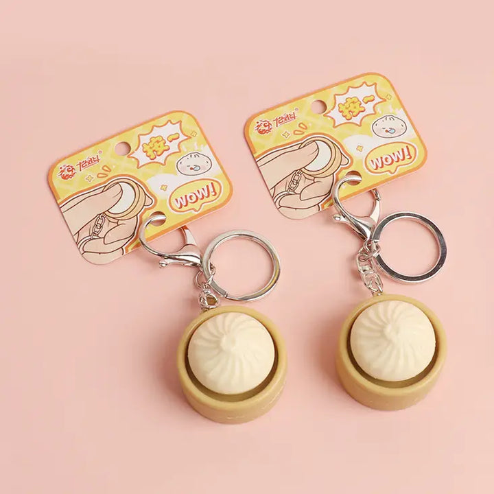 keychain shaped like a dumpling that has a clicking function in the middle. 