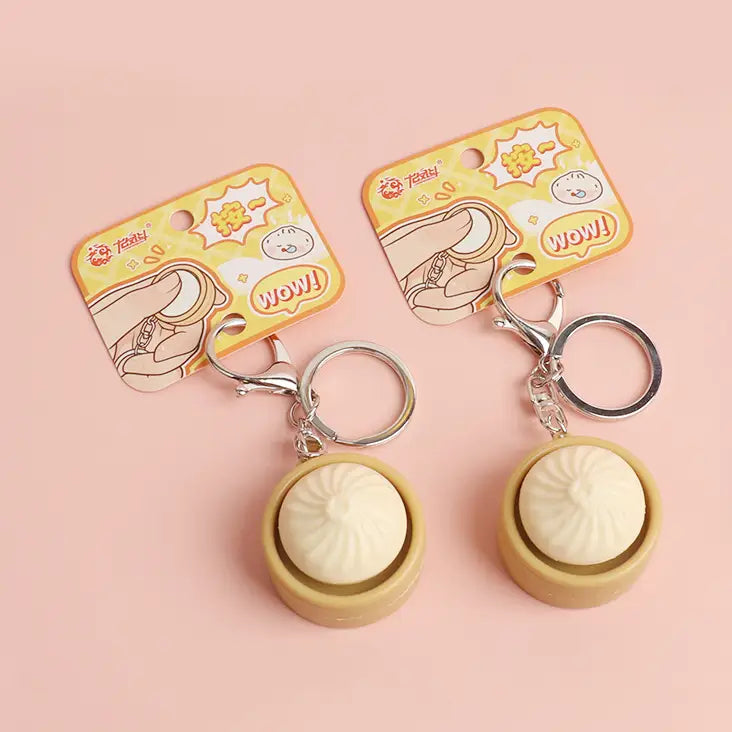 keychain shaped like a dumpling that has a clicking function in the middle. 